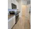 Kitchen with white cabinets, granite countertops, and stainless steel appliances at 522 Noble Ave, Davenport, FL 33837