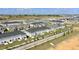 An aerial view showcases the neighborhood's well-planned layout with gray townhomes and green spaces at 697 Stoney Point Cir, Davenport, FL 33896