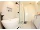 Modern bathroom featuring a soaking tub, glass shower, and sleek vanity at 697 Stoney Point Cir, Davenport, FL 33896