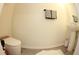 Powder room with a pedestal sink, towel rack, and modern toilet on wood-look floors at 697 Stoney Point Cir, Davenport, FL 33896