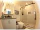 Bathroom with a granite sink, shower with glass doors, and white tile at 697 Stoney Point Cir, Davenport, FL 33896