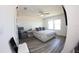 Bedroom featuring a ceiling fan, large windows, sliding glass door, chair, and vinyl flooring at 697 Stoney Point Cir, Davenport, FL 33896