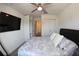 Bedroom with a ceiling fan, flat-screen TV, closet, mirror, and vinyl flooring at 697 Stoney Point Cir, Davenport, FL 33896