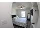 Bedroom with a ceiling fan, flat-screen TV, mirror, and vinyl flooring at 697 Stoney Point Cir, Davenport, FL 33896