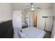 Bright bedroom featuring mirrored closet, ceiling fan and ensuite bath access at 697 Stoney Point Cir, Davenport, FL 33896