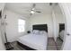 Well-lit bedroom with ceiling fan, mirror closet, and modern accents at 697 Stoney Point Cir, Davenport, FL 33896