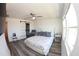Bedroom featuring a ceiling fan, large windows, sliding glass door, chair, and vinyl flooring at 697 Stoney Point Cir, Davenport, FL 33896