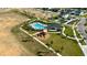 Overhead view of a community pool, playground, and recreation area nestled among palm trees and manicured lawns at 697 Stoney Point Cir, Davenport, FL 33896