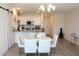 Open-concept kitchen and dining area with a chandelier, perfect for Gathering gatherings and entertaining guests at 697 Stoney Point Cir, Davenport, FL 33896