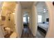 Hallway leading to bathroom and bedroom with neutral paint and flooring at 697 Stoney Point Cir, Davenport, FL 33896