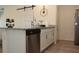 Modern kitchen features granite countertops, stainless steel appliances, and stylish barn door at 697 Stoney Point Cir, Davenport, FL 33896