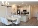 Eat-in kitchen features white cabinetry, stainless appliances, granite counters, and room to entertain at 697 Stoney Point Cir, Davenport, FL 33896