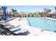 Large community pool with plenty of lounge chairs, umbrellas and views of the neighborhood at 697 Stoney Point Cir, Davenport, FL 33896