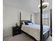 Bright bedroom with a comfortable bed and dark wood nightstand at 709 Centervale Dr, Celebration, FL 34747