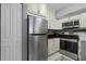 Clean kitchen with stainless steel appliances and off-white cabinets at 709 Centervale Dr, Celebration, FL 34747