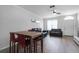 Open living area with leather couches, a dining table, and hardwood floors at 709 Centervale Dr, Celebration, FL 34747