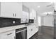 Modern kitchen featuring white cabinets, dark countertops, and stainless steel appliances at 740 Baltimore Dr, Orlando, FL 32810