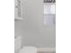 Simple, clean bathroom with a toilet and a small window for natural light at 7733 Belvoir Dr, Orlando, FL 32835