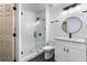Bathroom with glass enclosed shower, black hardware and a vanity at 827 Albi Ct, Kissimmee, FL 34759