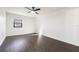 Bright bedroom featuring hardwood floors, a modern ceiling fan, and a window at 827 Albi Ct, Kissimmee, FL 34759