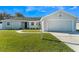 Charming single-story home with a well-maintained lawn and attached two car garage at 827 Albi Ct, Kissimmee, FL 34759