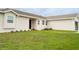 A well manicured lawn and garden beds lead to the front entrance of this single story home at 827 Albi Ct, Kissimmee, FL 34759