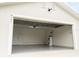 Open garage view showing epoxy flooring, water heater, and door to the house at 827 Albi Ct, Kissimmee, FL 34759