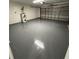 Spacious garage with epoxy floor and garage door perfect for parking or a workshop at 827 Albi Ct, Kissimmee, FL 34759