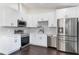 Modern kitchen featuring stainless steel appliances and white cabinets at 827 Albi Ct, Kissimmee, FL 34759