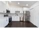 Modern kitchen featuring stainless steel appliances and white cabinets at 827 Albi Ct, Kissimmee, FL 34759