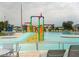 Community pool featuring a colorful water slide and lounge seating, perfect for summer fun at 827 Albi Ct, Kissimmee, FL 34759