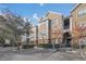 Tan colored building exterior with landscaping and parking at 8301 Elm Park Dr # 634, Orlando, FL 32821