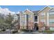 Tan colored building exterior with landscaping and parking at 8301 Elm Park Dr # 634, Orlando, FL 32821