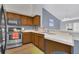 Kitchen with wood cabinets and stainless steel appliances at 8301 Elm Park Dr # 634, Orlando, FL 32821