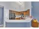 Kitchen with wood cabinets, stainless steel appliances, and breakfast bar at 8301 Elm Park Dr # 634, Orlando, FL 32821