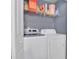 Bright laundry room with washer, dryer, and shelving for storage at 8301 Elm Park Dr # 634, Orlando, FL 32821