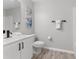 Clean bathroom with white vanity, black matte fixtures, and wood-look flooring at 937 Elkcam Blvd, Deltona, FL 32725