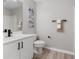 Clean bathroom with white vanity, black matte fixtures, and wood-look flooring at 937 Elkcam Blvd, Deltona, FL 32725