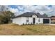 A newly built home with a white exterior, gray roof and landscaping at 937 Elkcam Blvd, Deltona, FL 32725