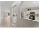 Modern kitchen with white cabinets, stainless steel appliances, and light gray walls at 937 Elkcam Blvd, Deltona, FL 32725