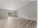 Spacious living room with gray walls and wood-look vinyl flooring and sliding glass doors at 937 Elkcam Blvd, Deltona, FL 32725