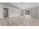 Living room with gray walls, wood-look vinyl flooring, and access to a bathroom at 937 Elkcam Blvd, Deltona, FL 32725