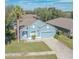 Single-Gathering home with a two-car garage and palm tree at 9850 Hidden Dunes Ln, Orlando, FL 32832