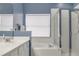 Clean bathroom with soaking tub, shower, and white vanity at 9850 Hidden Dunes Ln, Orlando, FL 32832