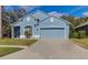 Two-car garage and a nicely landscaped front yard at 9850 Hidden Dunes Ln, Orlando, FL 32832