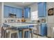 Modern kitchen featuring blue cabinets and a spacious island at 9850 Hidden Dunes Ln, Orlando, FL 32832