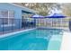 Sparkling blue pool with safety fence at 9850 Hidden Dunes Ln, Orlando, FL 32832