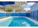 Refreshing pool with safety fence at 9850 Hidden Dunes Ln, Orlando, FL 32832