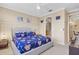 Well-lit bedroom with a king-size bed and an ensuite bathroom at 1009 Wood Cv, Kissimmee, FL 34743