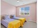 Charming bedroom with two twin beds and a large window at 1009 Wood Cv, Kissimmee, FL 34743